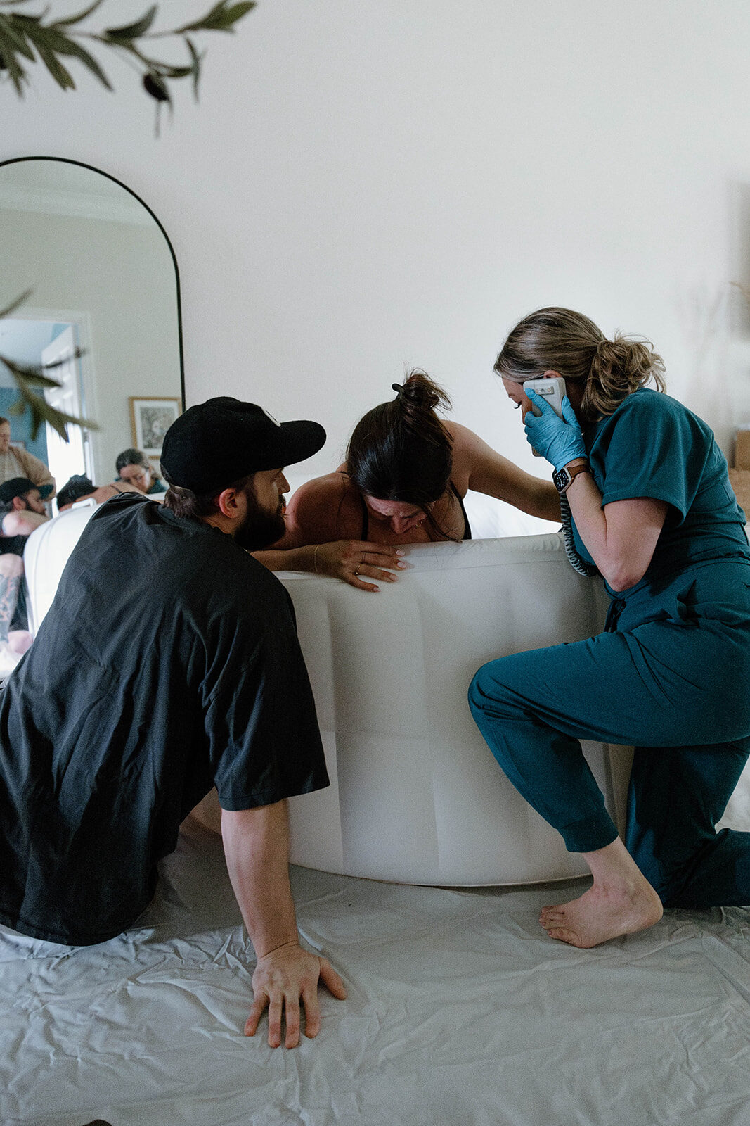 Rhonda supporting a mother laboring in a birth pool