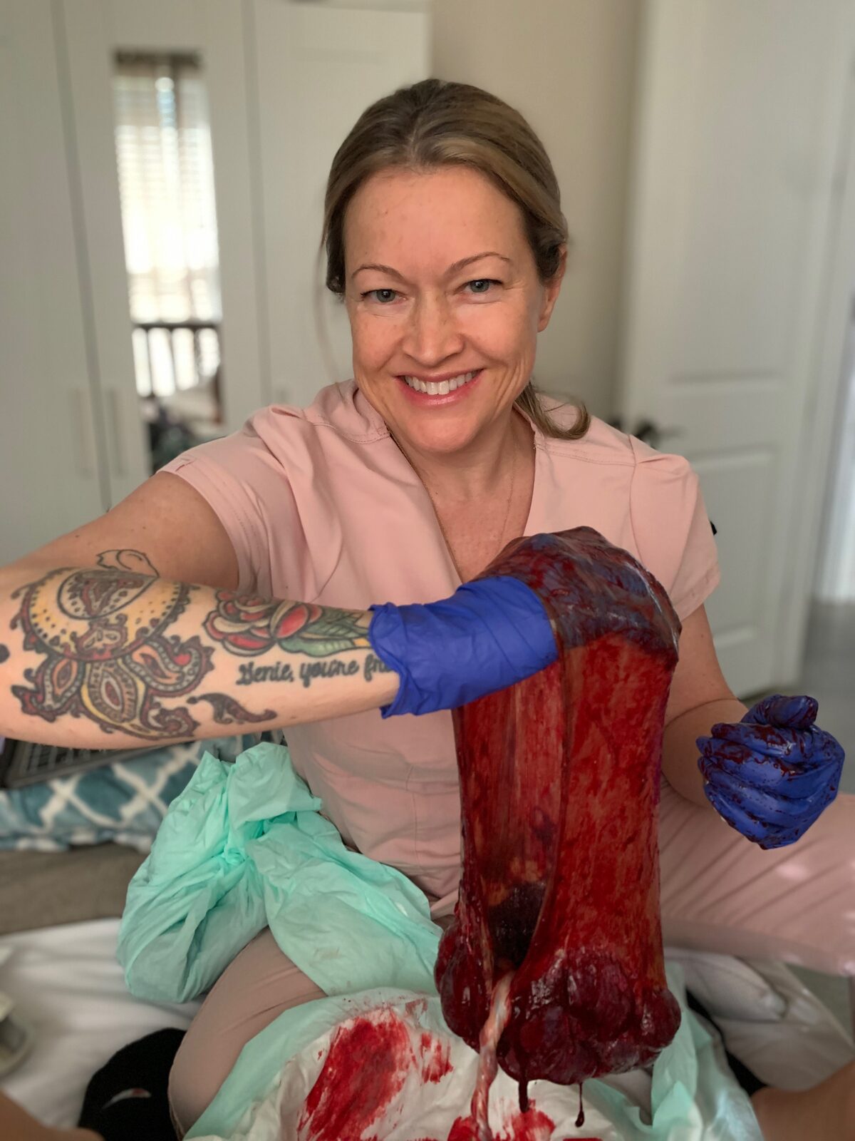 Rhonda examining the placenta after a birth