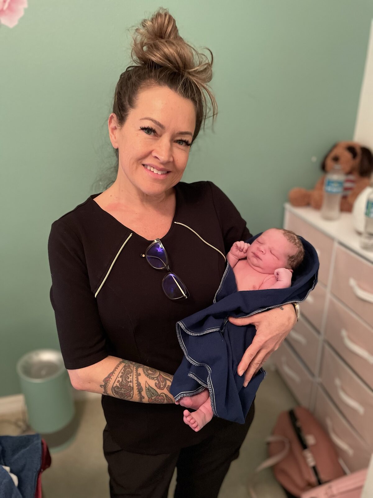 Rhonda holding a swaddled newborn