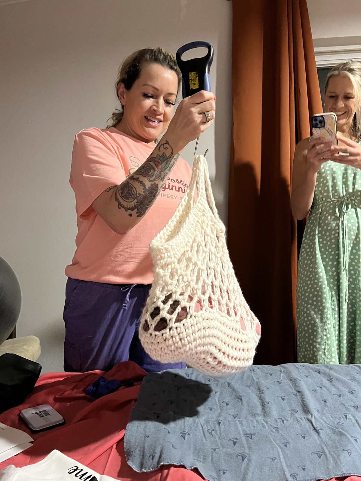 Rhonda weighing a baby in the crochet sling scale